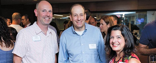 Two smiling men and a smiling woman